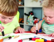 Children colouring in together Children colouring in together
