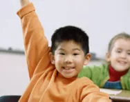 Children putting their hands up in class Children putting their hands up in class