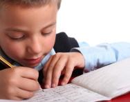 Close up of boy practising writing