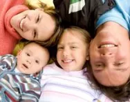 Family lying on the floor looking happy