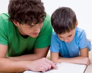 Father and son reading together