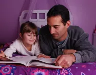 Father and daughter reading together