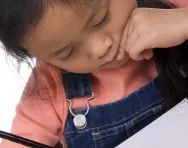 Child writing in pencil