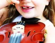 Girl laughing with violin Girl laughing with violin