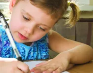 Girl practising handwriting Girl practising handwriting