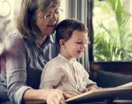 Grandmother and child reading together