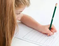Girl writing in exercise book Girl writing in exercise book