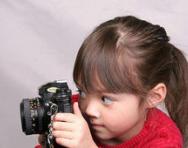 Little girl looking through camera