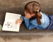 Little girl reading a book