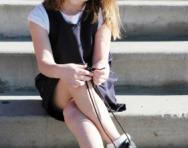 Little school girl tying shoelaces
