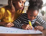 Mother and daughter writing Mother and daughter writing