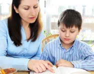 Mother helping son with homework
