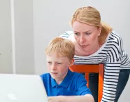 Mum and child looking at a computer
