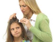 Mum looking for lice in daughter's hair