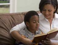 Mum reading a book with her son