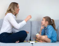 Parent and child playing a board game
