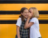 School girls sharing secrets