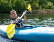 Summer camp boy kayaking Summer camp boy kayaking