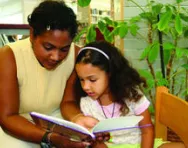 Teacher reading with pupil Teacher reading with pupil