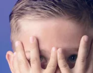 Boy hiding behing his hands Boy hiding behind his hands
