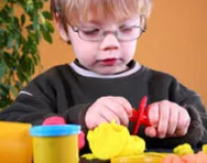 Nursery child playing with playdough Nursery child playing with playdough