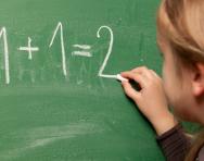Girl doing maths on a chalkboard