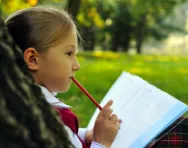 Girl writing in park Girl writing in park