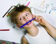 Stressed out child chewing on a pencil Stressed out child chewing on a pencil