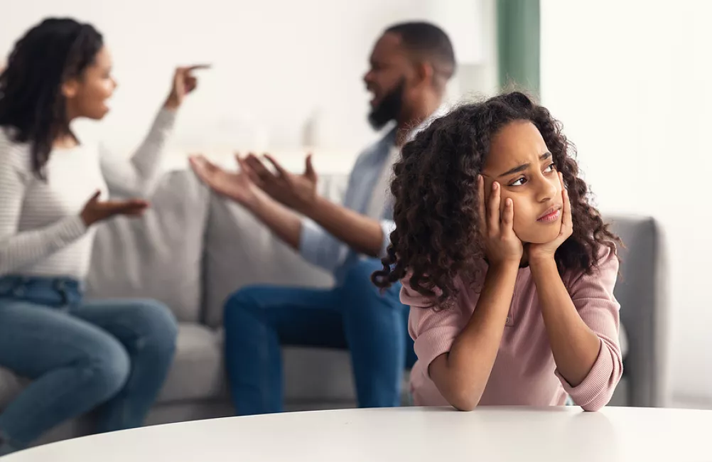 Child looking sad as parents argue