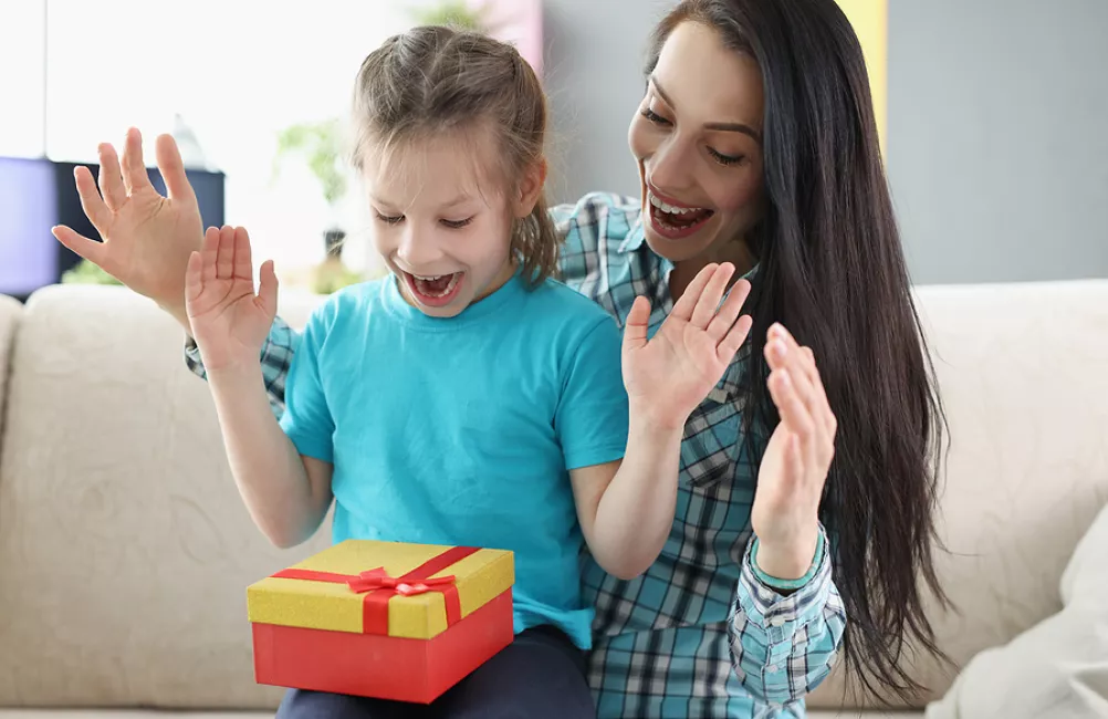 Mother and child opening gift