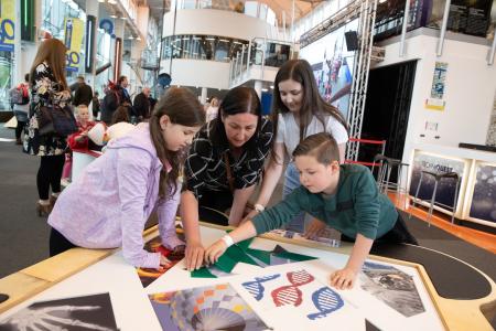 Adults taking part in educating children about science and maths at the museum